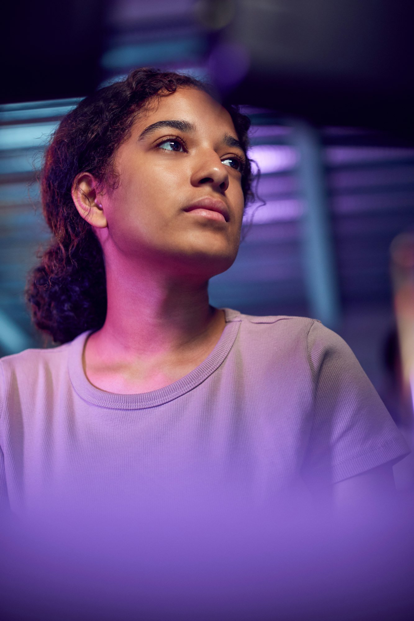 Female Teenage Hacker Sitting Between Computer Screens Bypassing Cyber Security