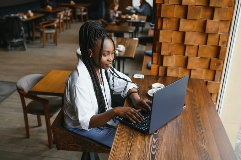Focused young african american businesswoman or student looking at laptop