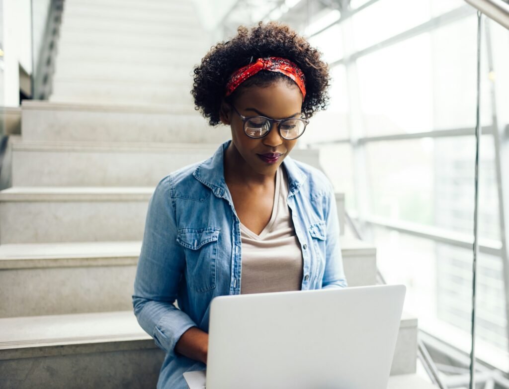 Young African student sitting on stairs prepping for an exam
