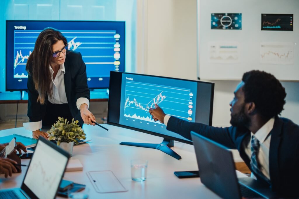 Multiracial coworkers discussing data on computer